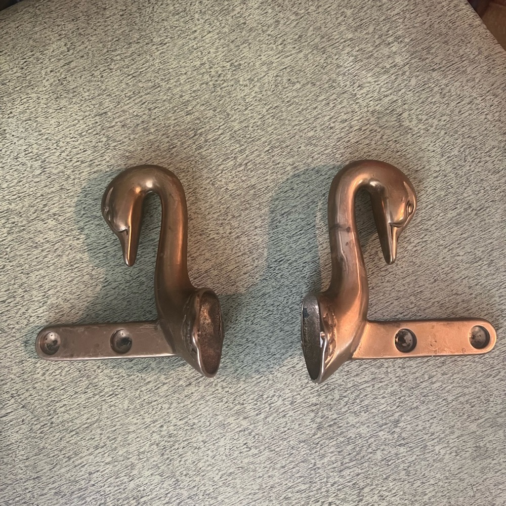 Gorgeous vintage brass swan head rack ends